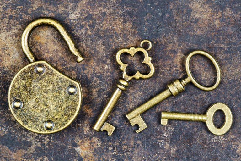 Keys and unlocked padlock on a rusty grunge metal background, escape room concept